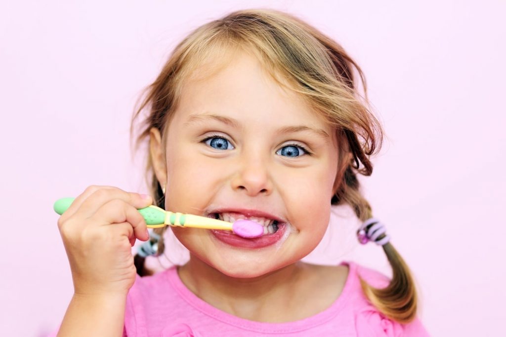 Child brushing her teeth
