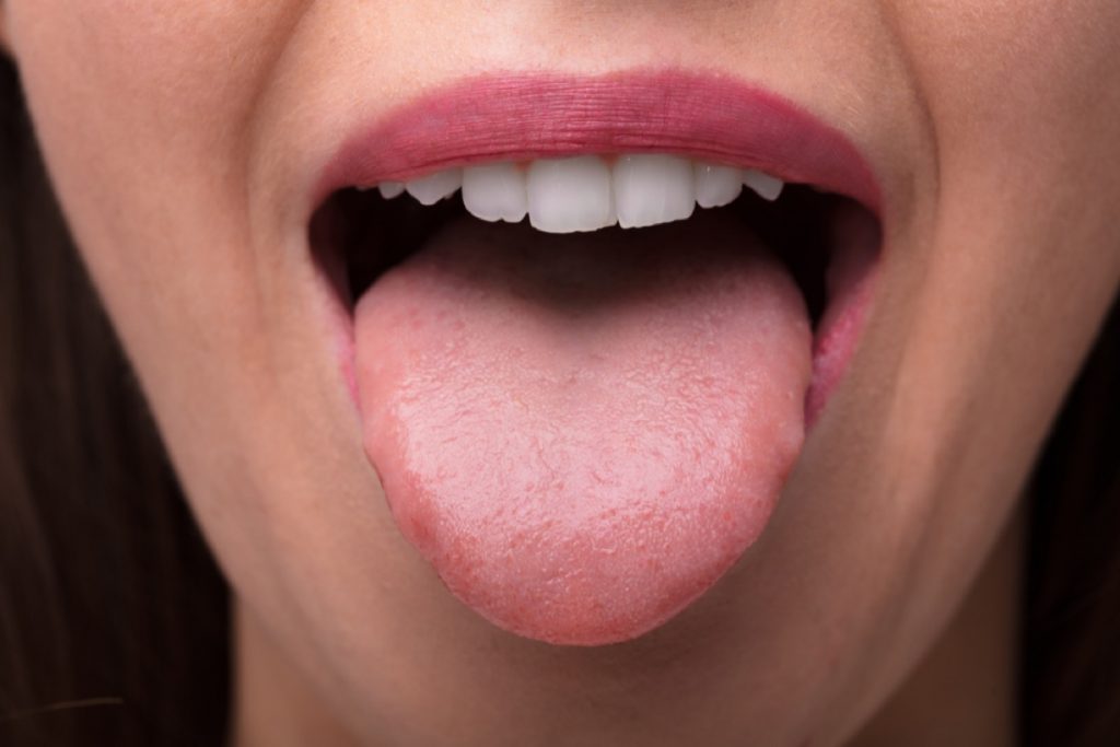 The tongue of a young woman